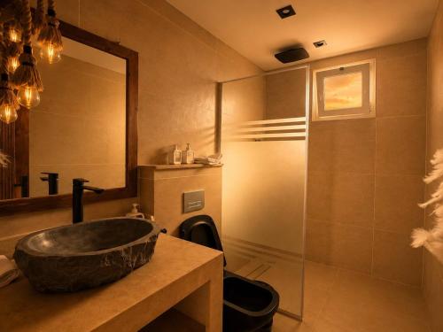 a bathroom with a stone sink and a shower at Isis Dahab in Dahab