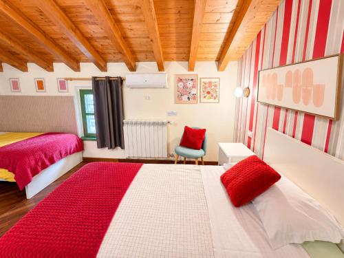 a bedroom with two beds and a chair in it at B&B La Borasca in Casalpusterlengo