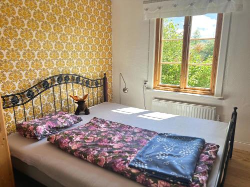 a bed with two pillows on it in a bedroom at Hus Hammerstrand in Hammarstrand