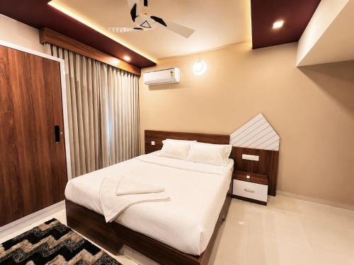 a bedroom with a large bed in a room at Mirage 8D Inn in Vythiri