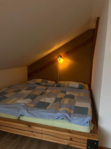 a bed with a wooden headboard in a room at Studio-Style Apartment in Spreenhagen