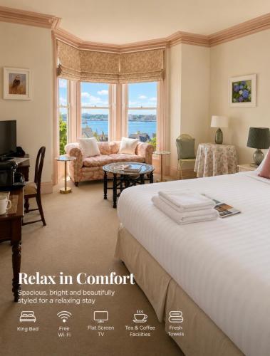 a hotel room with a bed and a living room at Lynwood house in Cobh