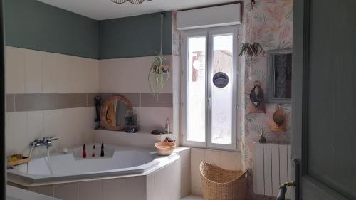 a bathroom with a sink and a window at les hirondelles de Barrou in Saint-Jean-de-Barrou