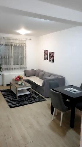 a living room with a couch and a table at Elly in Modriča