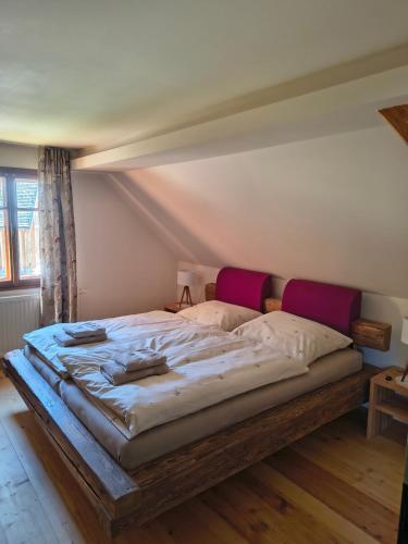 a bedroom with a large bed in a room at Das Kothberg in Lunz am See
