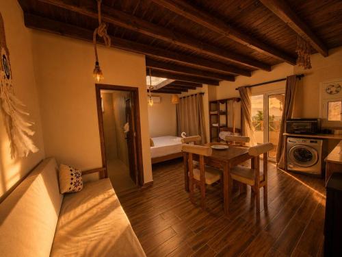 a room with a table and a room with a bed at Isis Dahab in Dahab