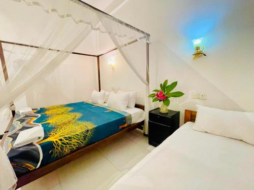 a bedroom with a bed with a canopy at Soul Breeze in Arugam Bay