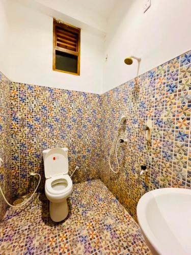 a bathroom with a toilet and a sink at Soul Breeze in Arugam Bay