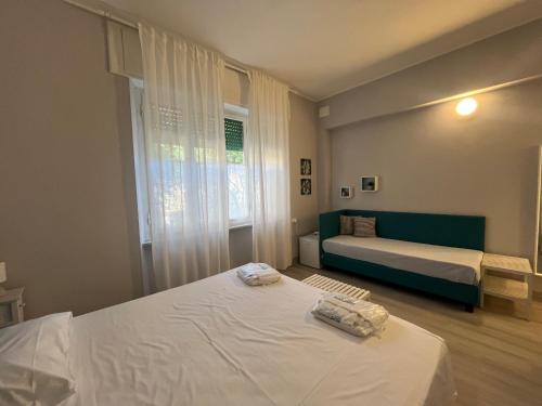 a bedroom with two beds and a window at Bed and coffee Rooms Portoferraio in Portoferraio
