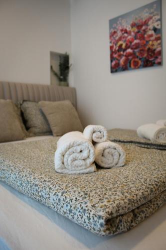 a bed with two rolled up towels on it at Studio Henigman in Dolenja Vas