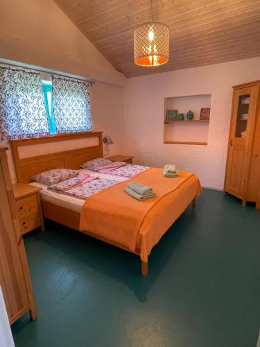 a bedroom with a large bed in a room at Krk Houses in Kornić