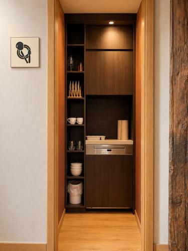 a walk in pantry with wooden cabinets and a shelf at Malerweg Residenz in Pirna