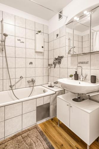 a white bathroom with a tub and a sink at MOLA Apartments - Panoramablick, Balkon, 5 Pers, Bahnhofsnähe, Parkplatz in Herdecke