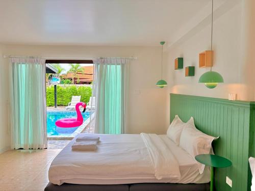 a bedroom with a large bed and a swimming pool at A1-Mountain View Private Pool Villa-บางแสน in Chon Buri