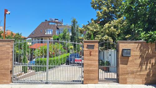 a gate in front of a house with a yard at Dimana in Chernomorets