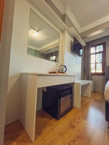 a kitchen with a desk and a sink in a room at Uz Hotel Premium in Safranbolu