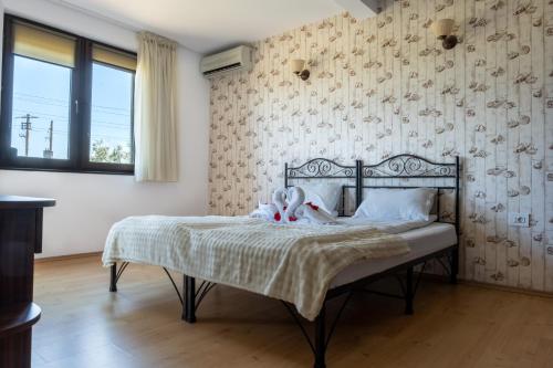 a bedroom with a bed with two stuffed animals on it at Porto Franco Sulina in Sulina