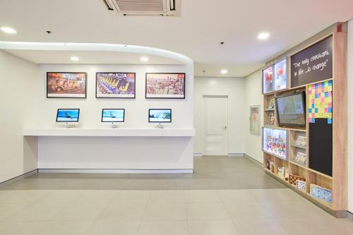 a lobby of a store with computers on the wall at Red Planet Makati Avenue Manila in Manila