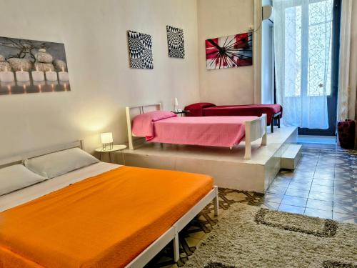 a bedroom with two beds and a table and chairs at Casa Cenzina in Cosenza