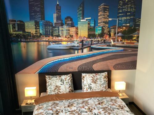 a bedroom with a view of a city skyline at B&B DownUnder in Vlissingen