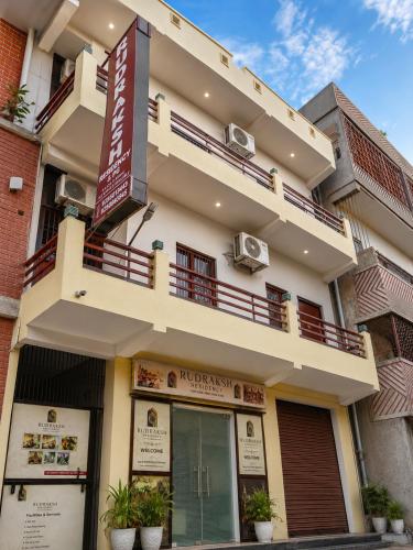 a building with a balcony on top of it at Rudraksh Residency in Varanasi