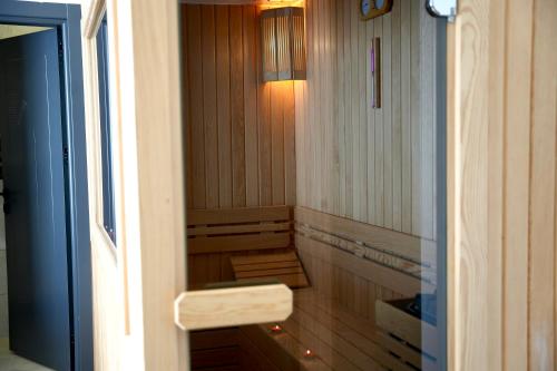 a small sauna with a bench in a room at Aerohub Grand Hotel in Arnavutköy