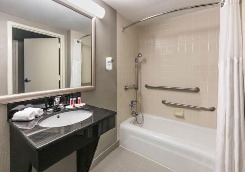 a bathroom with a sink and a tub and a shower at Boutique Hotel in Texarkana