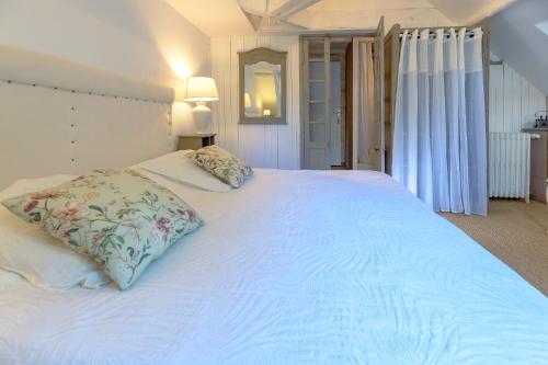 a large white bed with two pillows on it at Chambre duo in Sainte-Gemme-la-Plaine
