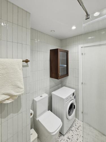 a bathroom with a toilet and a tv on the wall at The Retro Suite Kato Paphos 2 min to the beach in Paphos