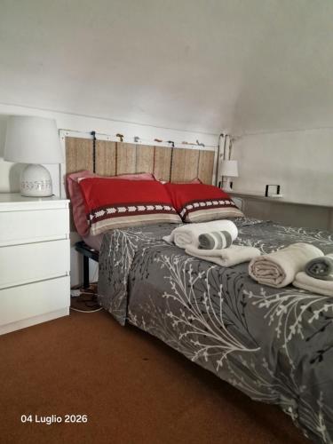 a bedroom with a bed with towels on it at Mivida Casa vacanze in Turin