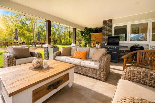 a living room with a couch and a table at Spacious 6BR Mansion with Pool Sauna BBQ in Gold Coast