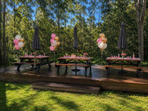 a group of picnic tables with balloons on a deck at Spacious 6BR Mansion with Pool Sauna BBQ in Gold Coast