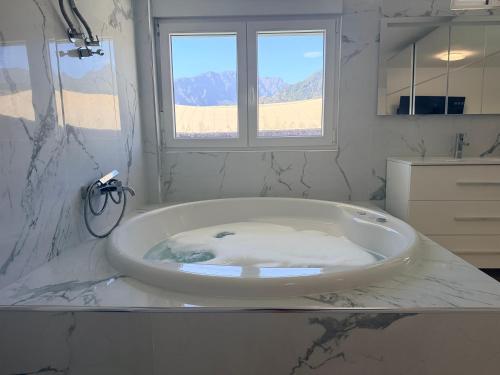 a white bath tub in a bathroom with a window at Lagoon Suits in San Borondón
