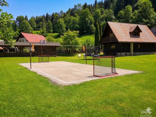 a tennis court with a net in a yard at Chata Sipkova I in Terchová