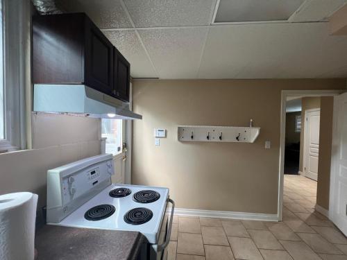 a kitchen with a stove top oven in a room at Luxurious Vacation in Welland