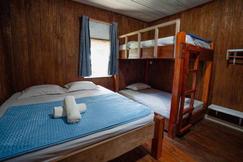 a bedroom with two bunk beds and a ladder at Likat Surf House in Tua Pejat