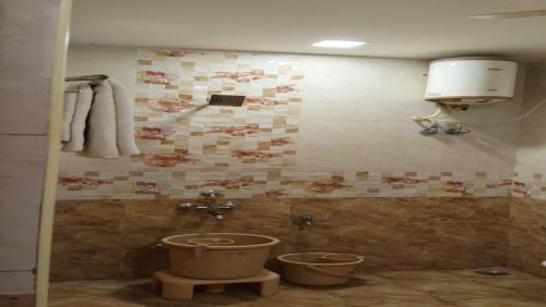 a bathroom with a toilet and a sink at Raya's Inn in Kumbakonam