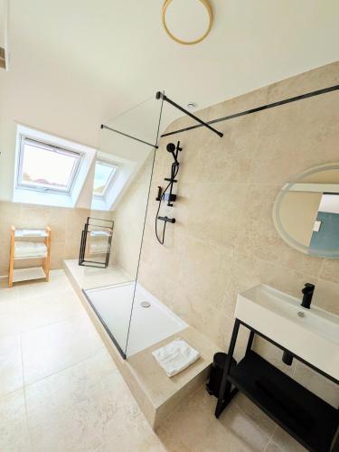 a bathroom with a glass shower and a sink at Hotel Ker Vennaik in Bénodet