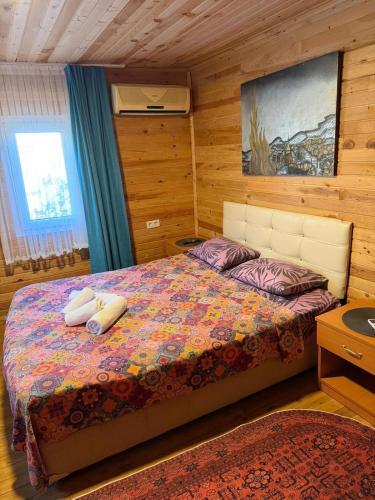 a bedroom with a bed with two pillows on it at Obelix Bungalows in Fethiye