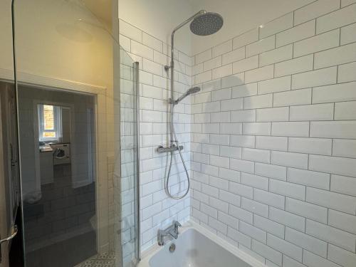 a bathroom with a shower and a bath tub at Dunes Apartment Troon in Troon