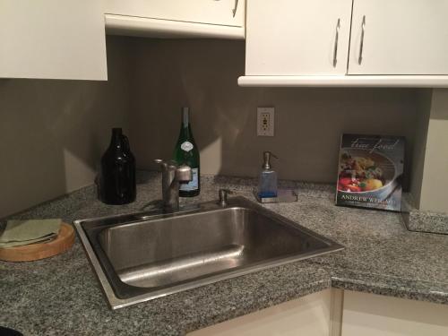 a kitchen counter with a sink and a bottle of wine at Downtown Big 1 Bedroom #20I in Atlanta