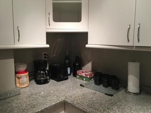 a kitchen counter with white cabinets and a microwave at Downtown Big 1 Bedroom #20I in Atlanta
