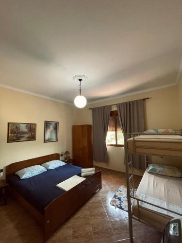 a bedroom with two bunk beds and a lamp at 3 Roots Villa in Krujë