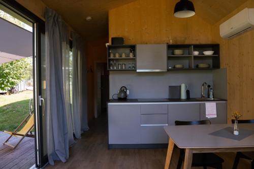 a kitchen with a counter and a table in a room at Wellnester Tiny Houses in Losheim am See in Losheim