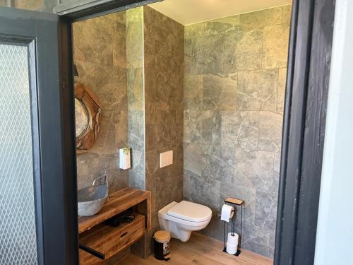 a bathroom with a toilet and a sink at Balcony by Giorgi - Centre de Bastogne in Bastogne