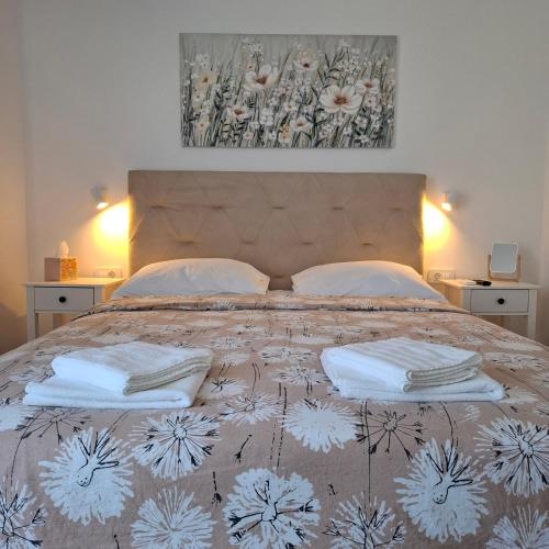 a bedroom with a bed with two towels on it at Room Mate in Malinska