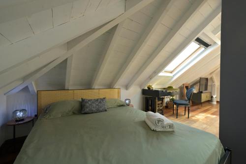 a bedroom with a large bed in a attic at Alassio Black Loft in Alassio