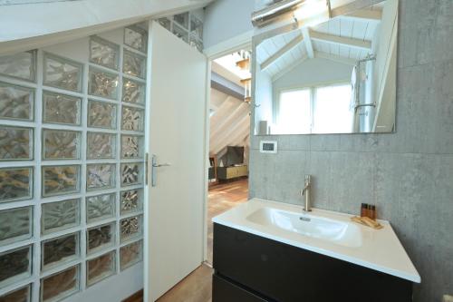 a bathroom with a sink and a mirror at Alassio Black Loft in Alassio