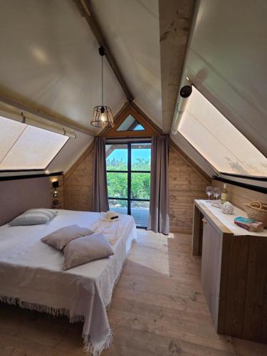 a bedroom with a bed in a room with skylights at Terre e Torri Country Resort in Lascari