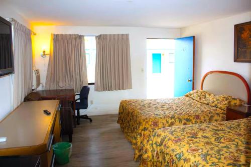 a hotel room with two beds and a desk at Stevenson Motel Federal Way near I 5 in Federal Way